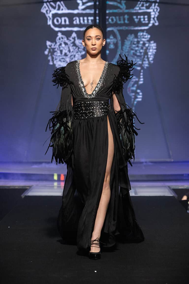 A model walks the On Aura Tout Vu couture runway wearing a sparkling ebroidered silk shiffon dress