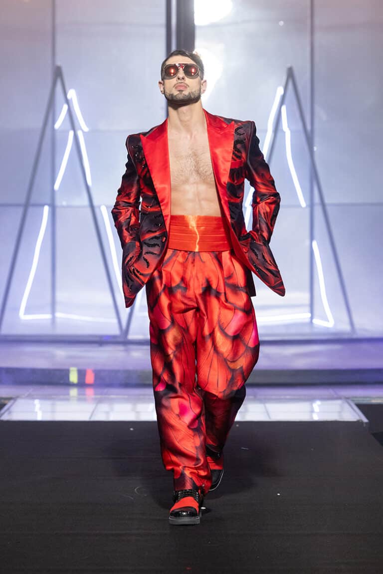 A male model walk on aura tout vu show wearing red custom print tuxedo