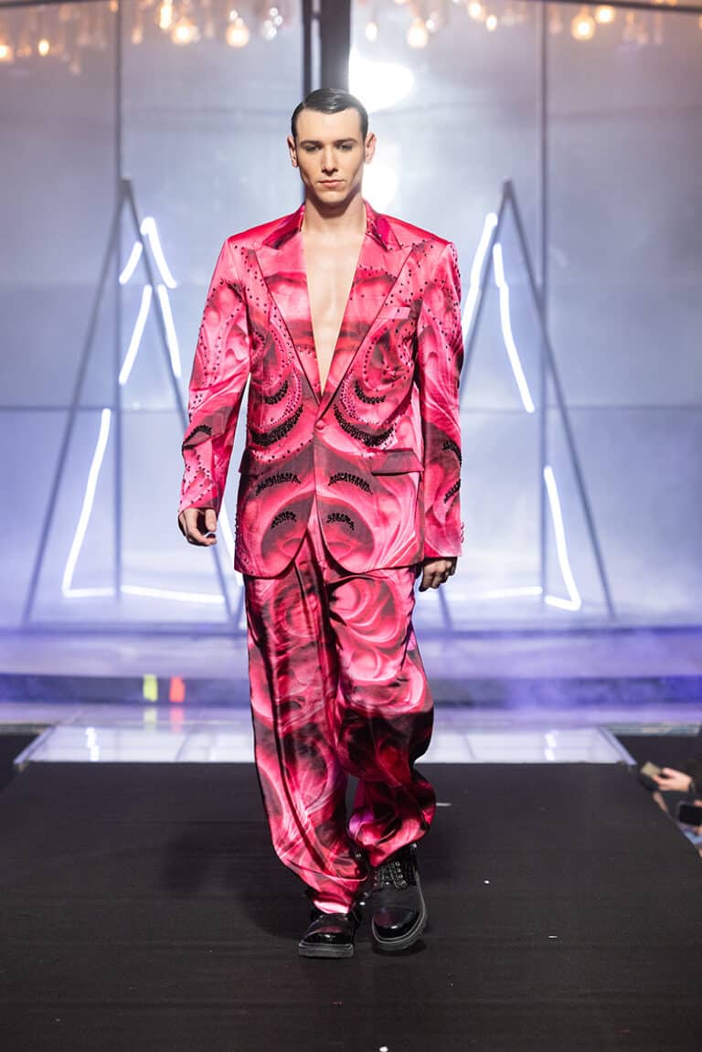 A male model walk on aura tout vu show wearing pink custom print tuxedo