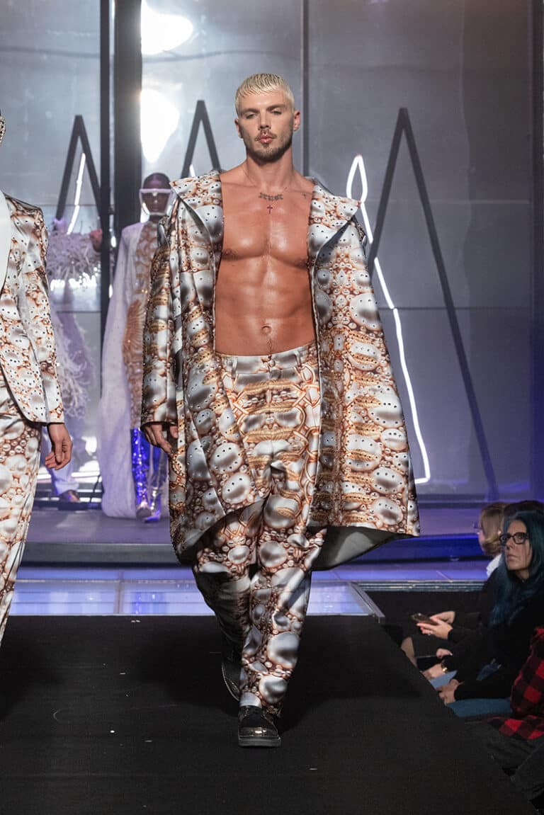 A male model walk on aura tout vu show wearing custom print tuxedo and printed pants