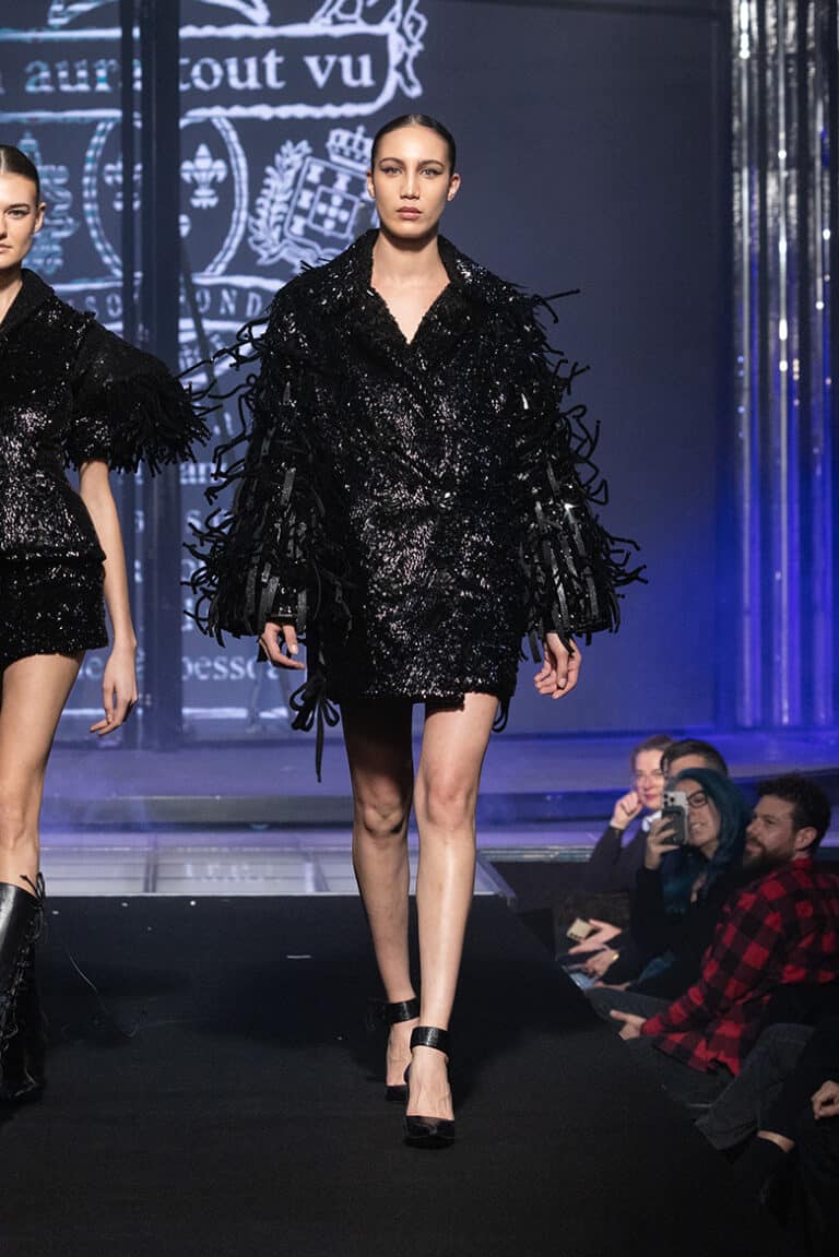 A model walk on aura tout vu show wearing coat embroidered with sequins and feathers