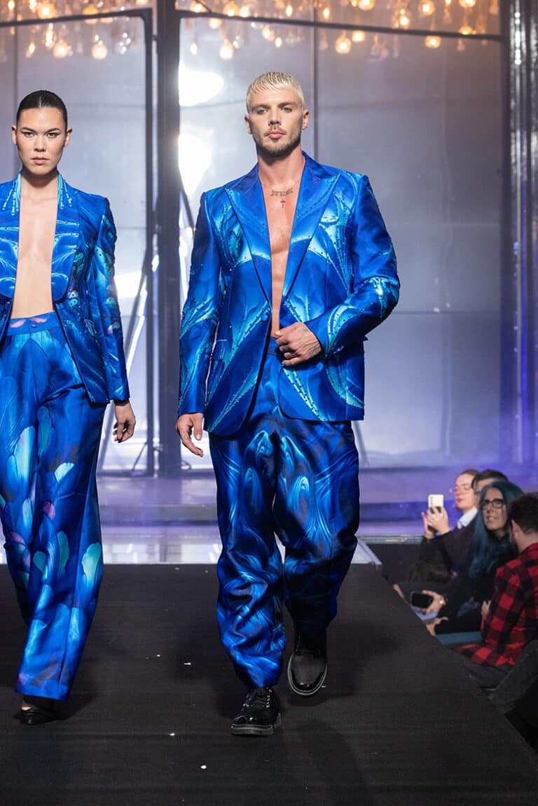 A male model walk on aura tout vu show wearing blue custom print tuxedo